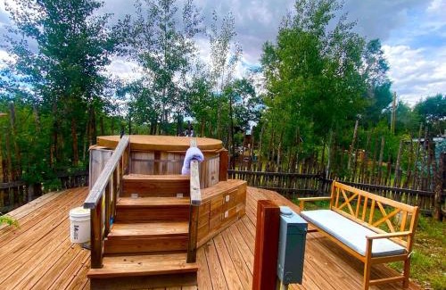 San Cristobal House | Log Casita Overlooking Pond and Waterfall near Taos, New Mexico