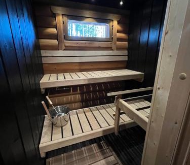 Yllasjarvi House | Logcabin, sauna, fireplace, view, kitchen