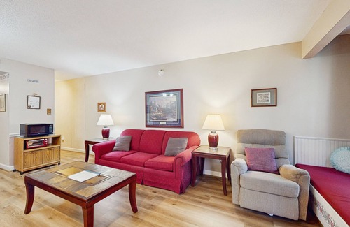 Chalet Village Condo | Lovely condo w/free attraction tickets, outdoor pool, fireplace & balcony