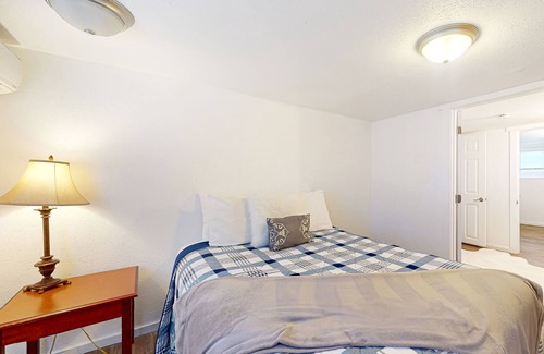 Haller Lake House | Lower-level home with spacious fenced backyard, playground, BBQ, firepit