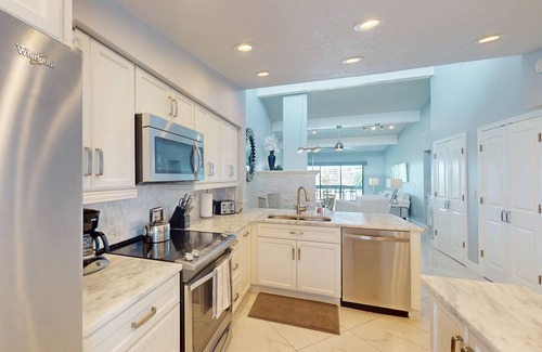 Capri Isle Condo | Luxurious Coastal Condo with Waterway Views, Pool, Balcony, and Steps to Treasure Island Beach.
