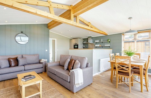 Middlezoy Ski Chalet | Luxurious lodge with vaulted ceilings and a welcoming feature fireplace.