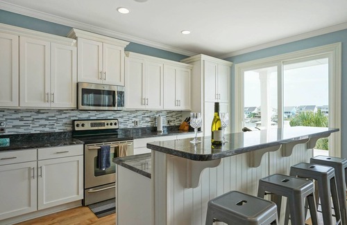 Sunset Beach House | Luxurious Sunset Beach Home On The Water With Pool, Boat Dock and Golf Cart