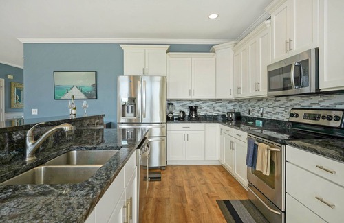 Sunset Beach House | Luxurious Sunset Beach Home On The Water With Pool, Boat Dock and Golf Cart