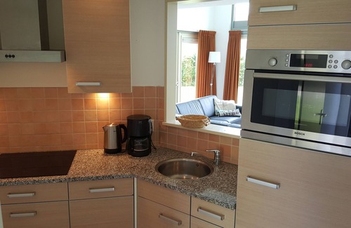 Kortgene Villa | Luxury detached vacation apartment by the river, lounge terrace and WLAN