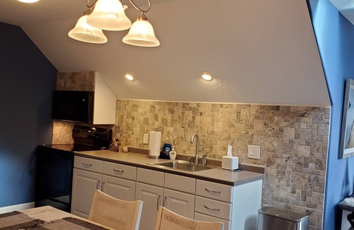 Rapids City House | Luxury river front two-bedroom carriage house with private deck and hot tub.