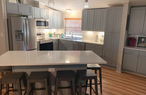 Kingsland House | Luxury WATERFRONT home with HEATED POOL AND SPA Sleeps 28+
