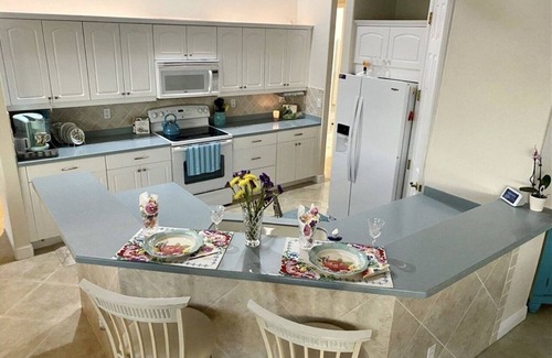 Caloosahatchee House | Luxury Waterfront Retreat-Heated Salt Pool Screened, Pedal Boat, Kayaks & Bikes
