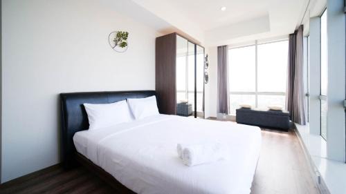 Surabaya Apartment | Minimalist with Beautiful View 2BR at Grand Sungkono Lagoon Apartment By Travelio