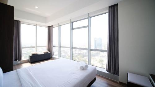 Surabaya Apartment | Minimalist with Beautiful View 2BR at Grand Sungkono Lagoon Apartment By Travelio