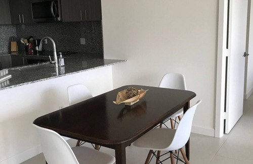 Doral Condo | Modern building, centrally-located condo,2 bedrooms/2 bathrooms, parking space.