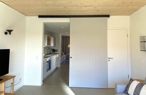 Hohwacht Apartment | Modern duplex apartment with rooftop terrace.
