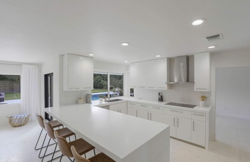 Moorings House | Modern Oasis: Private Beach Access. Minutes from Downtown & Optional Golf Cart