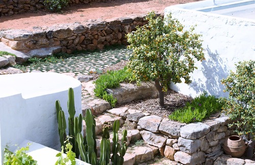 Santa Eulalia del Rio Villa | My Rental Homes - Villa Cave covered veranda with dining room and pool.