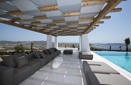 Tourlos Villa | My Rental Homes - Villa Opallia with spacious living and dining areas and a pool