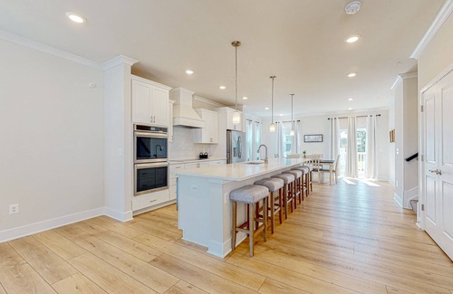 Ocean City House | Newly built row-end townhome with water view, pool access, patio, & balcony