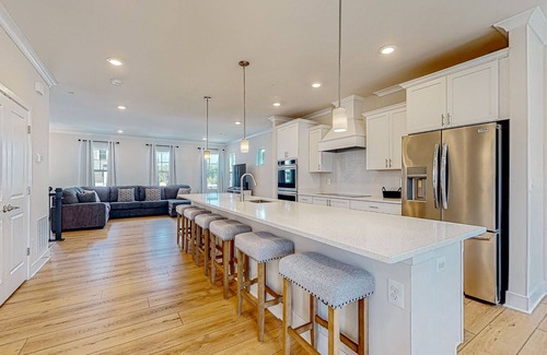 Ocean City House | Newly built row-end townhome with water view, pool access, patio, & balcony