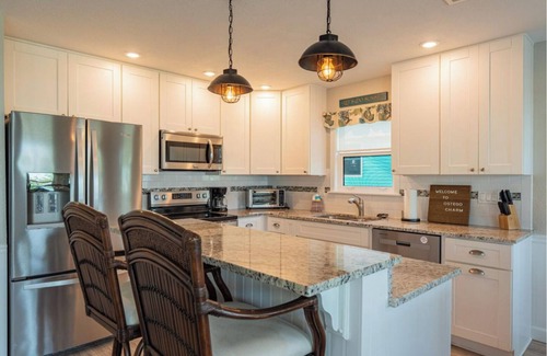 Fort Myers Beach House | Ostego Charm: Open floor plan, porch, lush landscape—walk-able to the Beach!