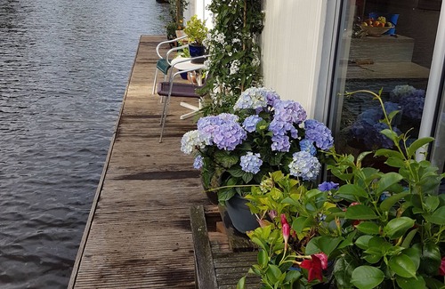Grachtengordel-West Boat Rental | Pantheos Houseboat in Prinsengracht with a view of the Westerkerk the Landmark.