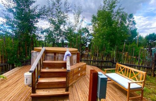San Cristobal House | Petite Log Cabin on Organic Farm in New Mexico