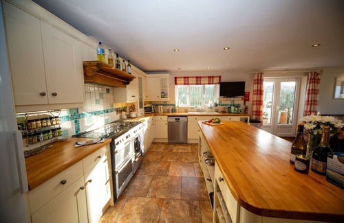 Trevone House | Polcarrek contemporary holiday home with parking and garden. Balcony with rural views
