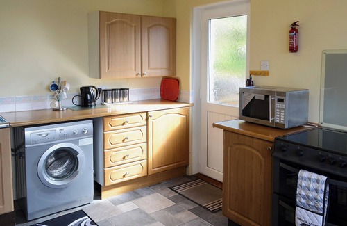 The Hebrides Cottage | Pretty whitewashed croft cottage perched on the hillside above the coastal village of Gairloch .