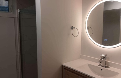 Northwest Calgary House | Private bathroom, living room with projector - Basement Suite for 3