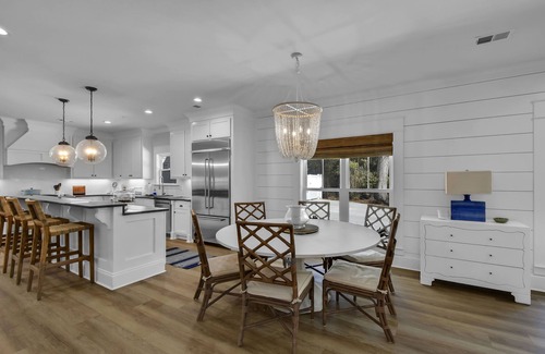 Saint Simons Island House | Private expansive backyard with pool, putting green and outdoor kitchen