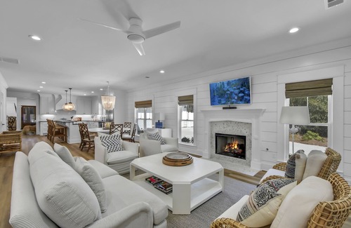 Saint Simons Island House | Private expansive backyard with pool, putting green and outdoor kitchen