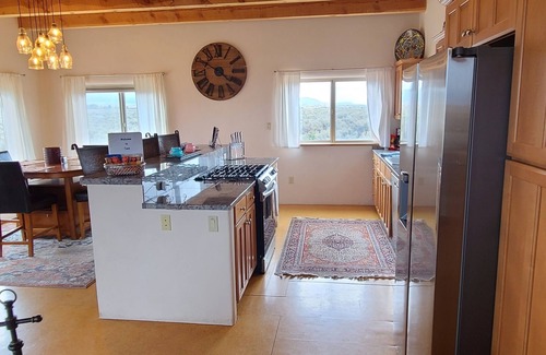 Taos House | Quiet, Pet Friendly Home with Mountain Views. Fenced area for dogs to roam