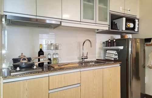 Bonifacio Global City Condo | Relax to a family size condo with fun games, popcorn and cinematic movie.