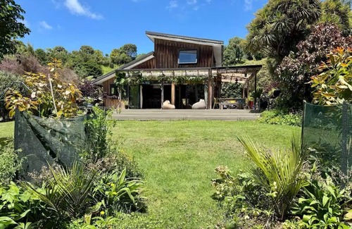Raglan House | Relax & Unwind at Wainui Creek Retreat a private & tranquil home by the beach