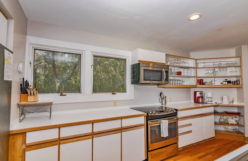 Bald Head Island House | Resting in treetop, two golf carts close to island amenities