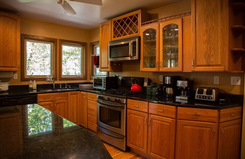 Elkins House | Riverfront luxury in the woods - main level master bedroom