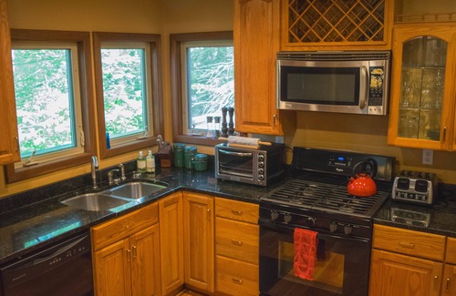 Elkins House | Riverfront luxury in the woods - main level master bedroom