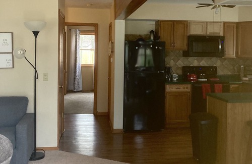 Lake House | Roomy home with spacious fenced in backyard and fire pit.