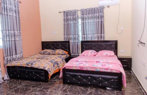 Benin City Apartment | Royal Guests Holiday Lets - A Modern 2-Bedroom Apartment with balcony, 24H CCTV, perfect for families, business or leisure