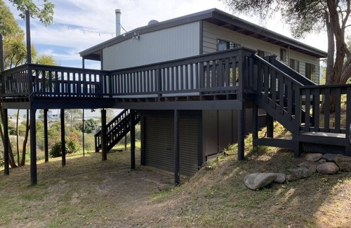 Goughs Bay Cabin | Rustic log cabin perched high on Goughs Bay