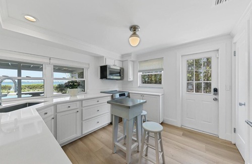 Cherokee Park House | Sarasota Renovated Waterfront Home with Dock Wide Open Bay Views Heated Pool