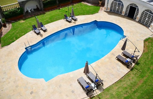 Limuru House | Scenic Escape: Elegant Room Overlooking Lush Grounds
