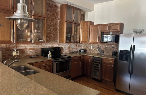 Wabasha Condo | Spacious 1 bed/1 bath historical loft offers exposed brick, and high ceilings.