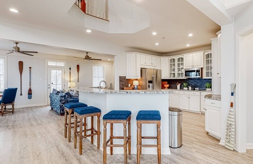 Sunset Island House | Spacious beachside home with fireplace, washer/dryer, pools, dock, & gym