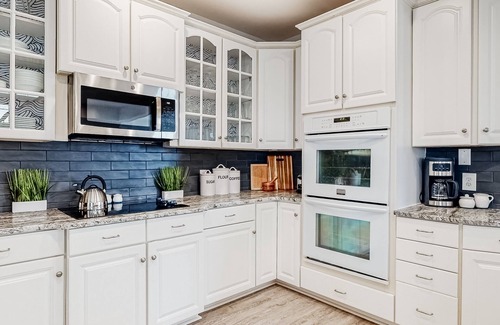 Sunset Island House | Spacious beachside home with fireplace, washer/dryer, pools, dock, & gym