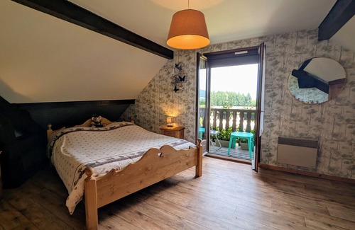 Anould Bed & Breakfast | Spacious room with balcony and heated pool access