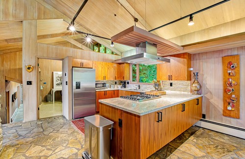 Innis Arden House | Spectacular mid-century home with two-story fireplace, huge deck, & water views