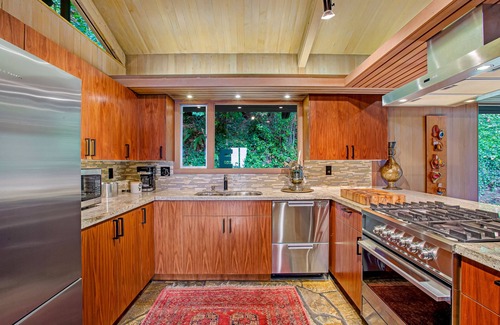 Innis Arden House | Spectacular mid-century home with two-story fireplace, huge deck, & water views
