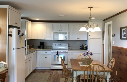 Coldwater Cottage | Spectacular sunset views and north chain lake front red cottage rental