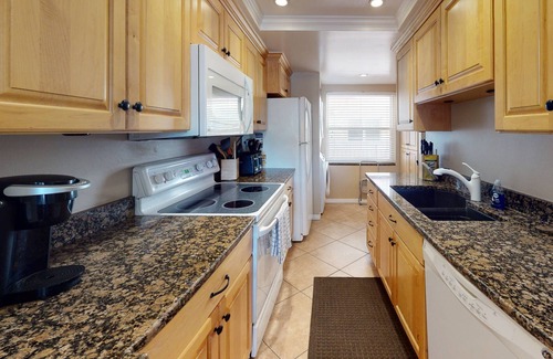 Madeira Beach Condo | Stay Across from Johns Pass Village. Heated Pool. Direct Beach Access. Secure Building.