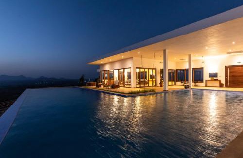Igatpuri Villa | StayVista at Sunset on the Lake - Infinity Lakeview Swimming Pool with Contemporary Interiors & Lavish Amenities