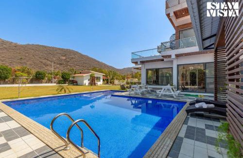 Bedla Villa | StayVista's Bella Dream - Mountain-View with Outdoor Pool, Lawn featuring a Gazebo & Indoor Games